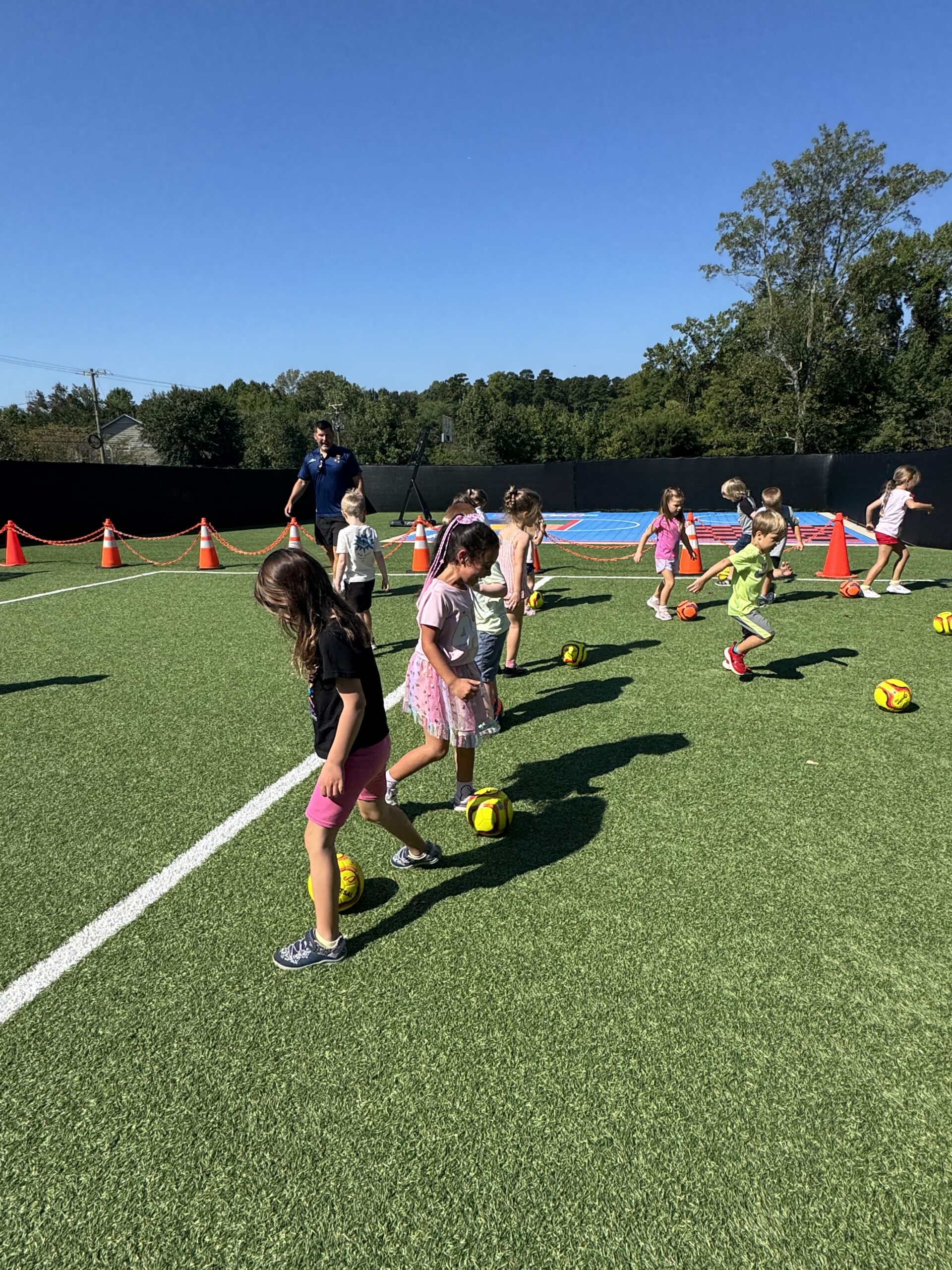 Children participating in a Footprints soccer activity at a partner location