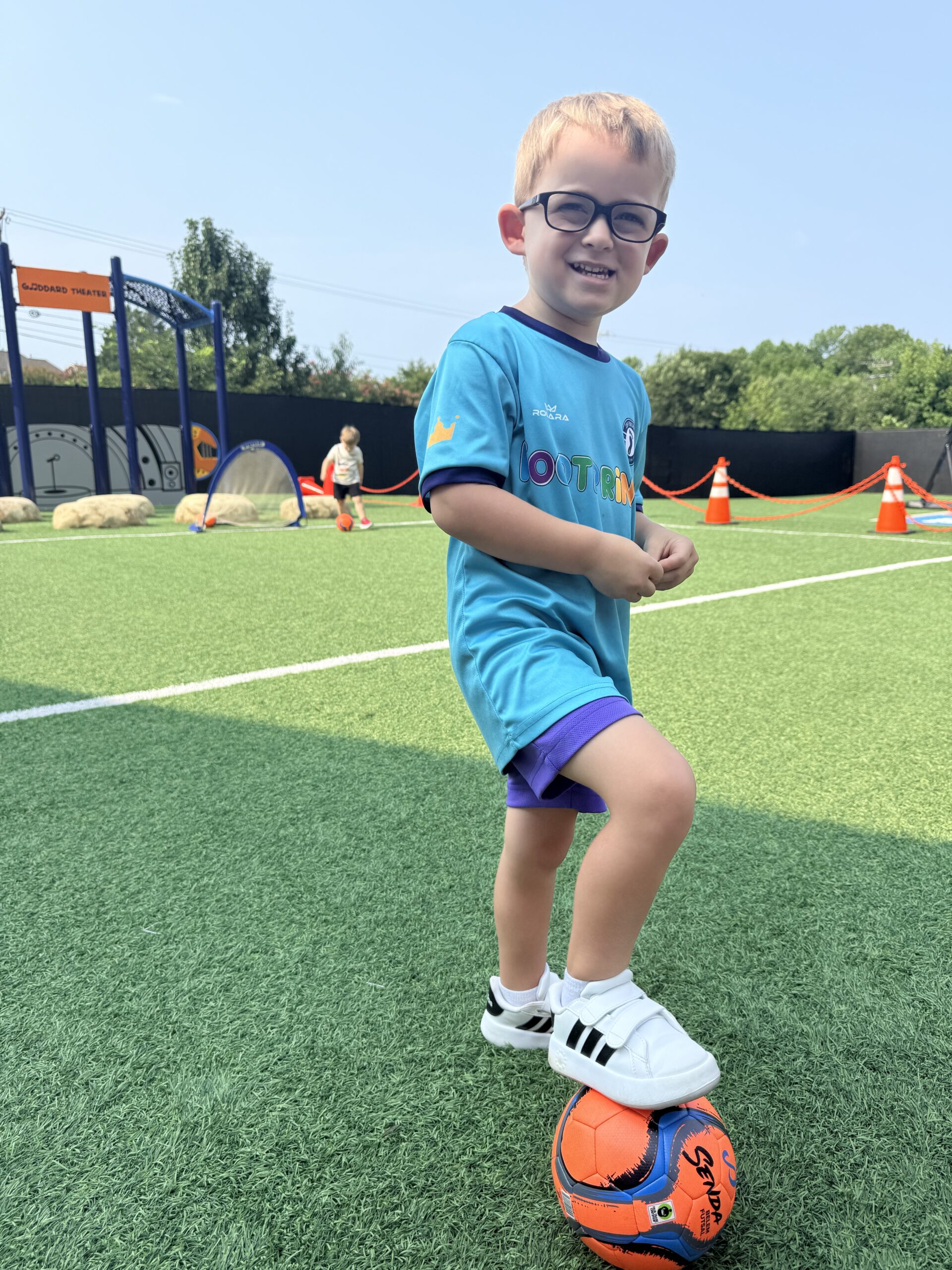 A smiling young Footprints soccer player