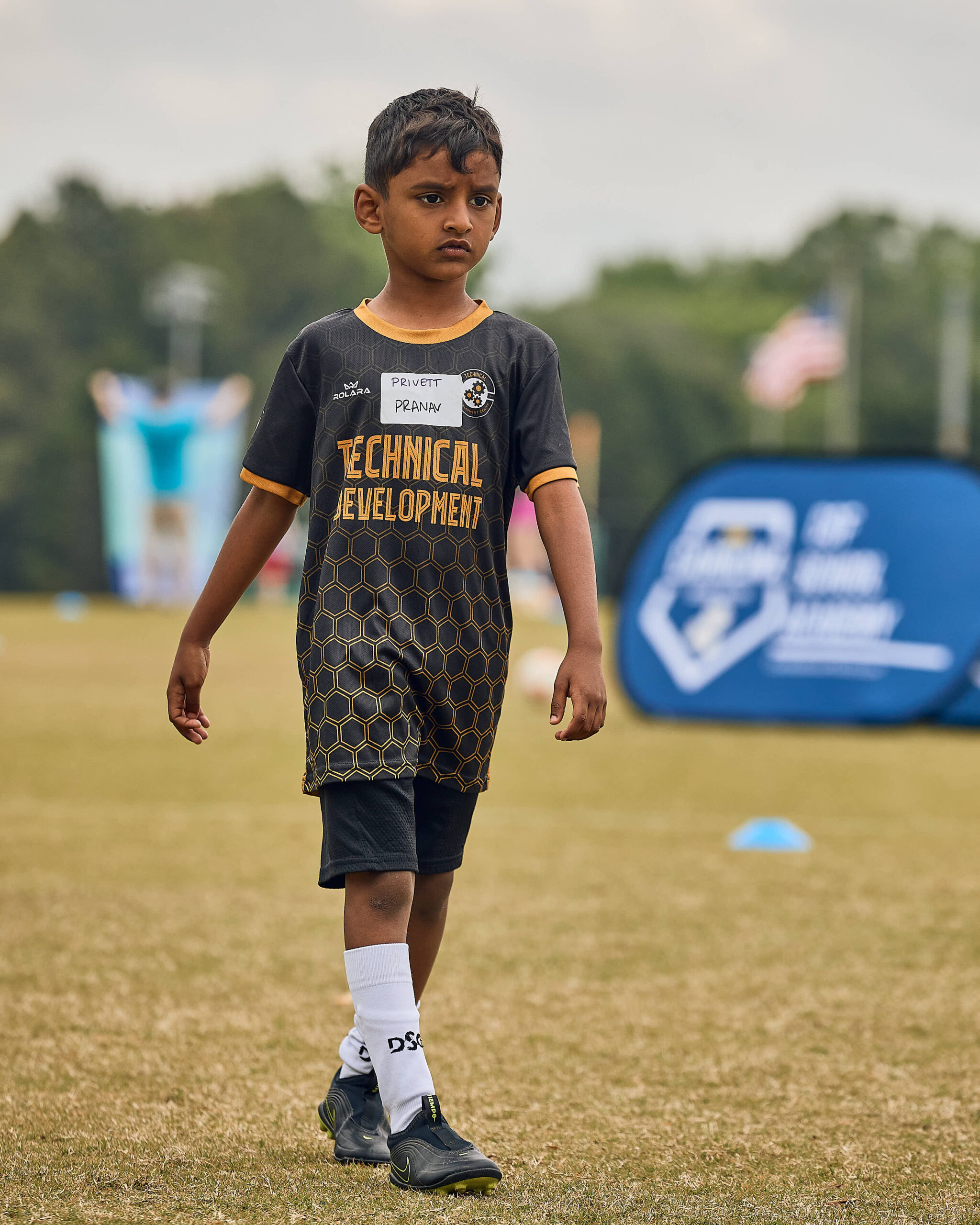 Young Technical Development Center player focused during an outdoor soccer session